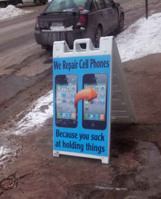funny-sign-repair-cell-phone-holding